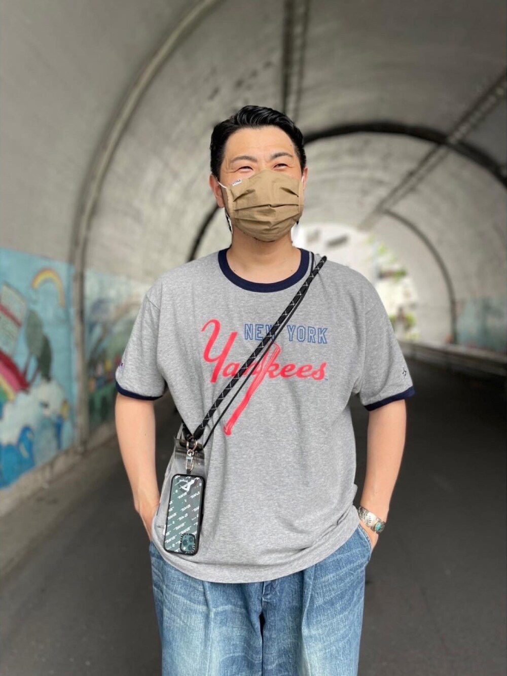 ブルー系のその他パンツ、グレー系のTシャツ/カットソー、その他のスマホグッズを着用したメンズの春コーディネートの2枚目の写真