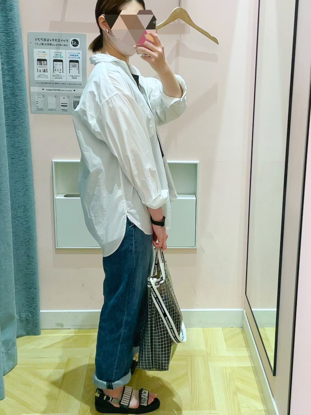 ブラック系のショルダーバッグ、ホワイト系のシャツ/ブラウス、ブルー系のデニムパンツを着用したレディースの春コーディネートの2枚目の写真