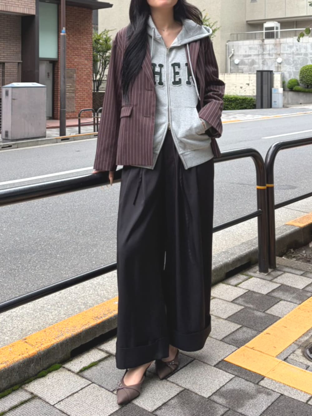ブラック系のその他パンツ、グレー系のパーカー、ブラウン系のパンプスを着用したレディースの秋コーディネートの2枚目の写真
