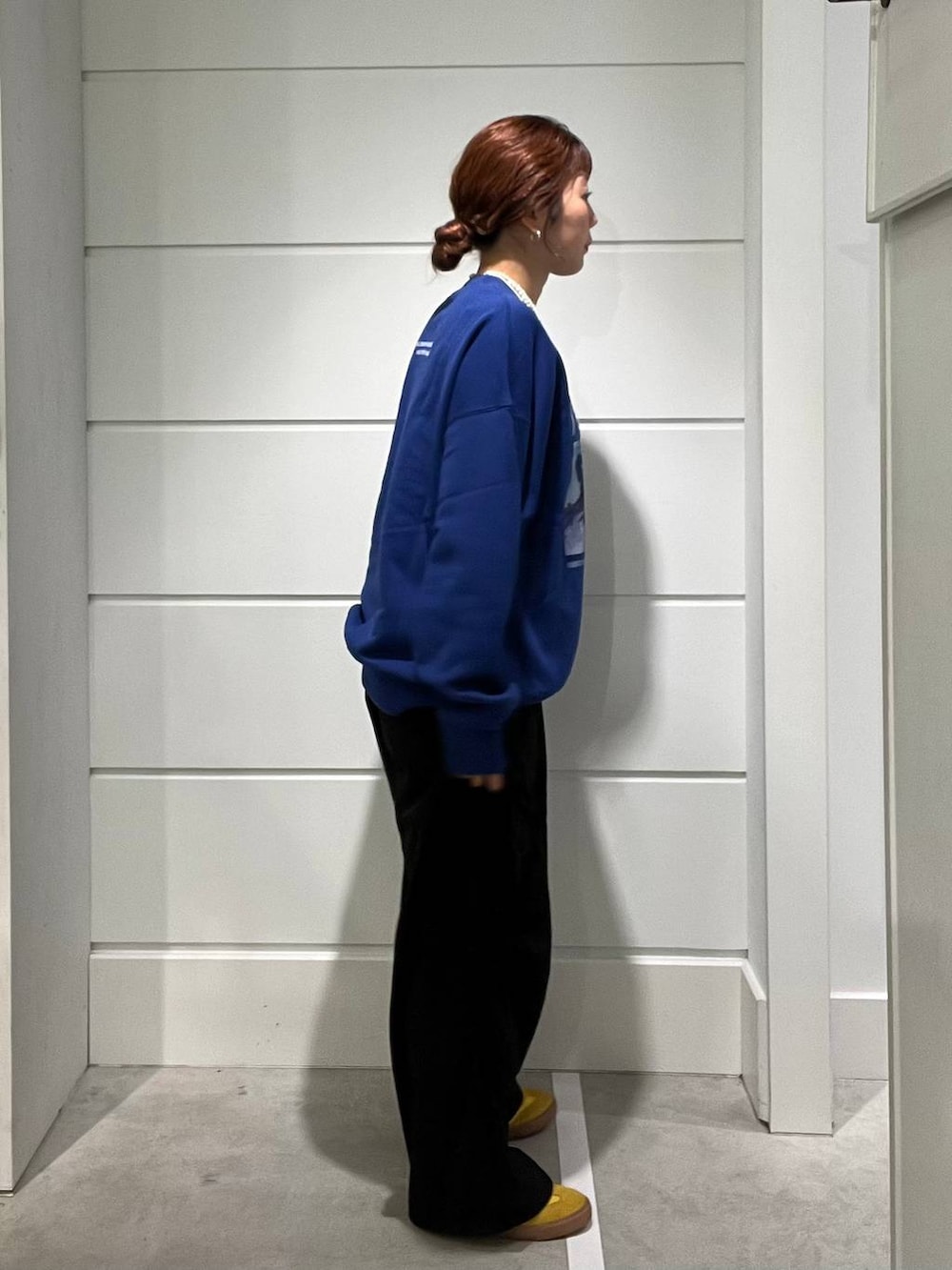 ブラック系のカーゴパンツ、ブルー系のスウェット、ホワイト系のネックレスを着用したメンズの秋コーディネートの2枚目の写真