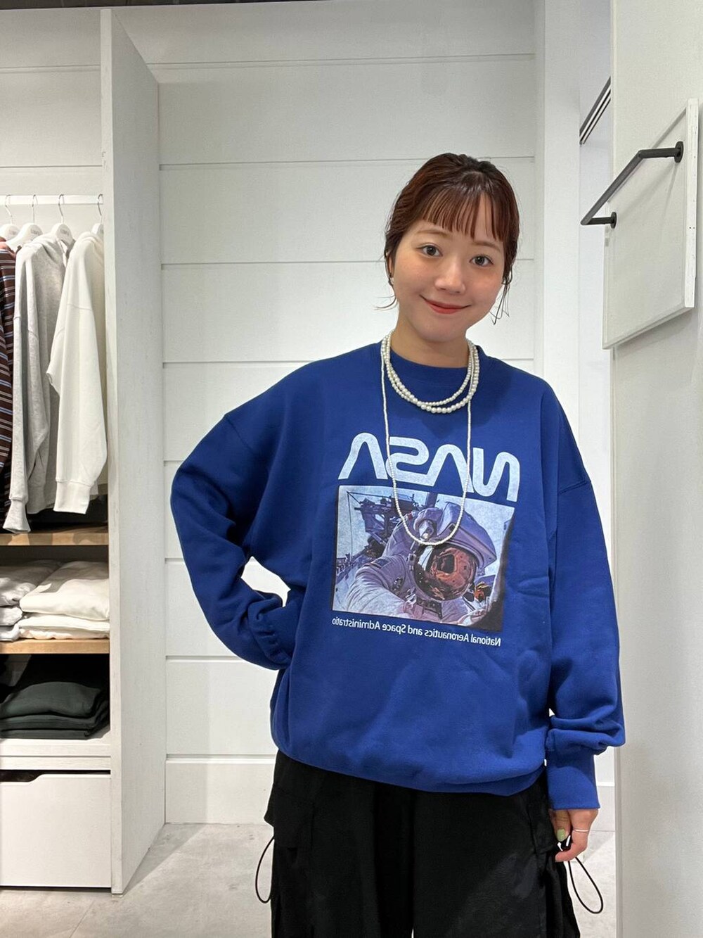 ブラック系のカーゴパンツ、ブルー系のスウェット、ホワイト系のネックレスを着用したメンズの秋コーディネートの4枚目の写真