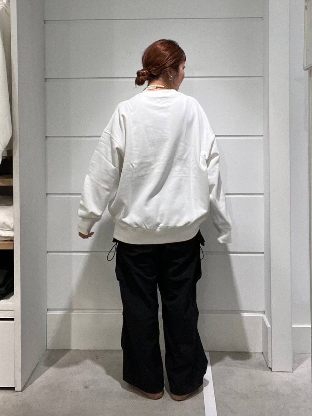 ブラック系のカーゴパンツ、ホワイト系のスウェット、ホワイト系のネックレスを着用したメンズの秋コーディネートの3枚目の写真