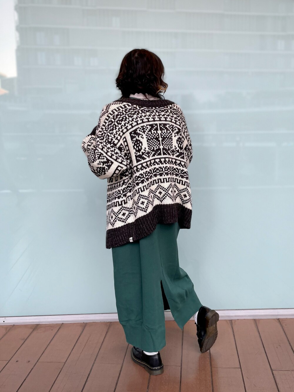 グリーン系のワンピース、ホワイト系のカーディガン/ボレロを着用したレディースの秋コーディネートの2枚目の写真