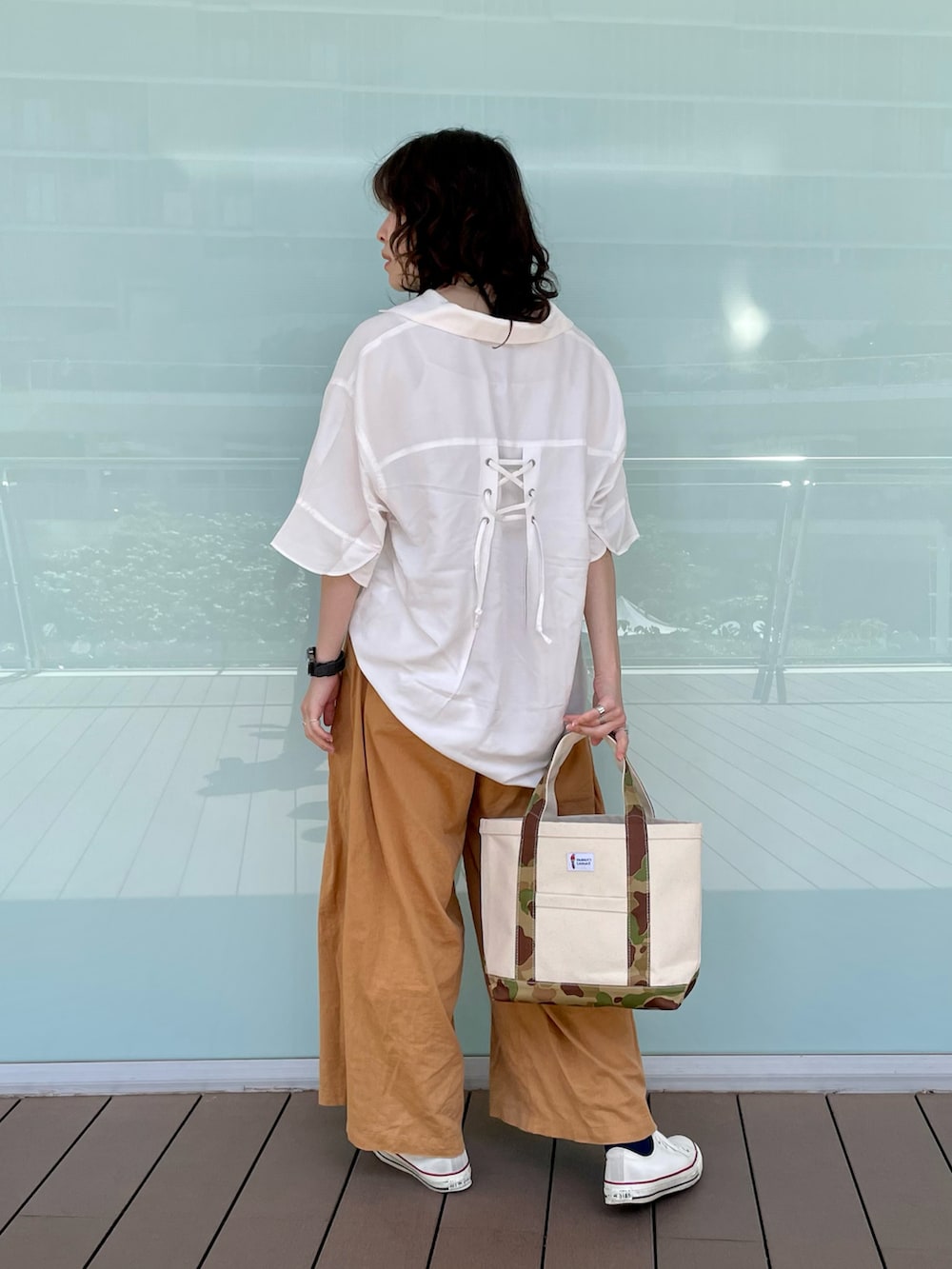 ホワイト系のシャツ/ブラウス、イエロー系のその他パンツ、グリーン系のトートバッグを着用したレディースの春コーディネートの2枚目の写真