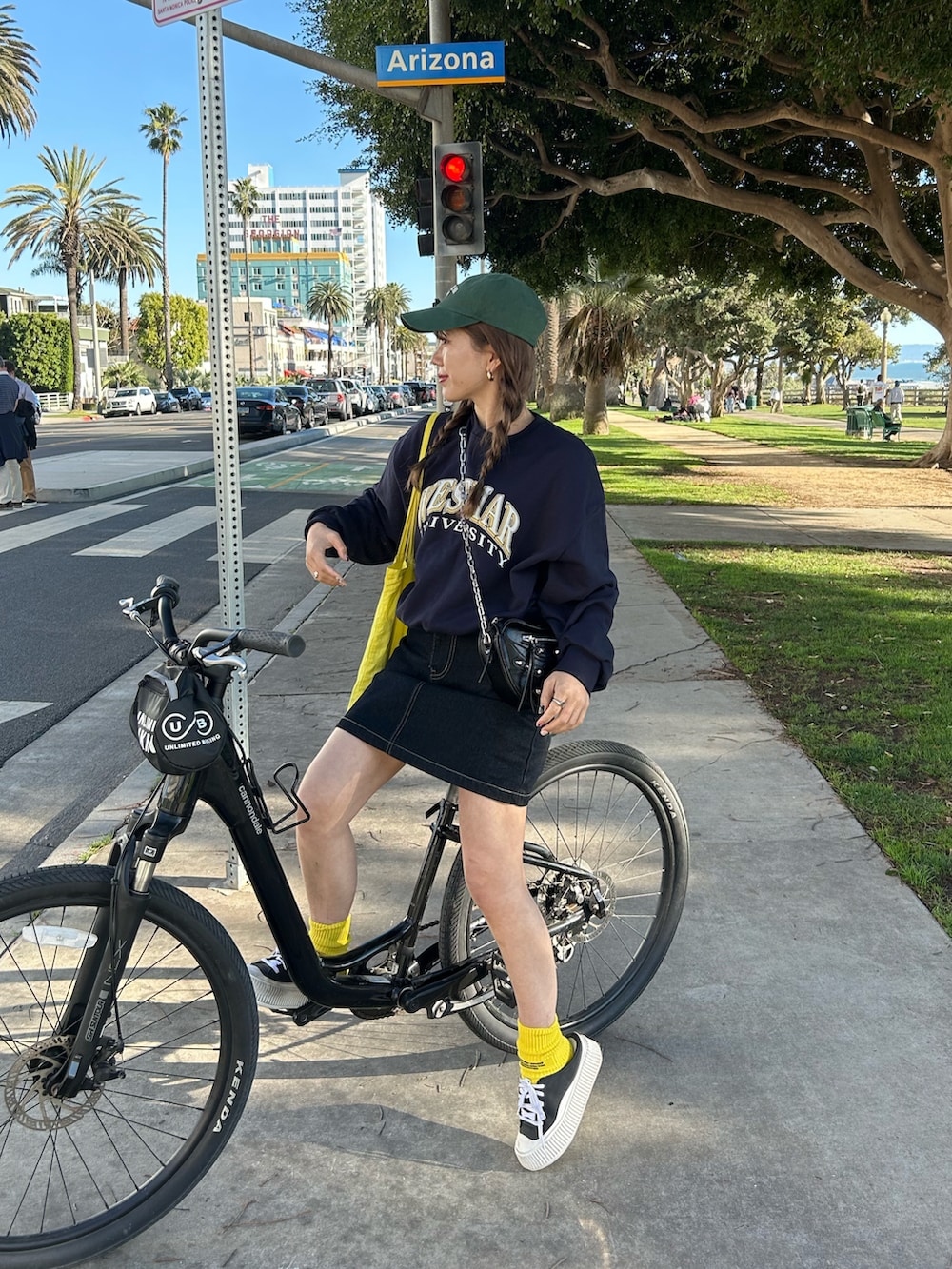 ブラック系のスウェット、ブルー系のデニムスカート、ブラック系のスニーカーを着用したレディースの冬コーディネートの2枚目の写真