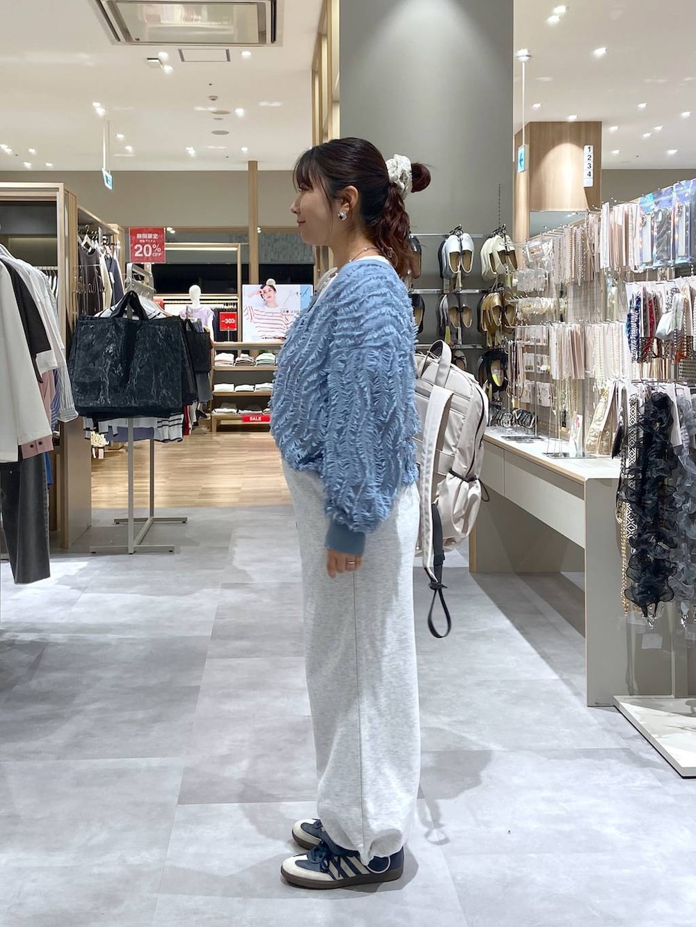 ホワイト系のTシャツ/カットソー、グレー系のスウェットパンツ、ホワイト系のバックパック/リュックを着用したレディースの春コーディネートの2枚目の写真