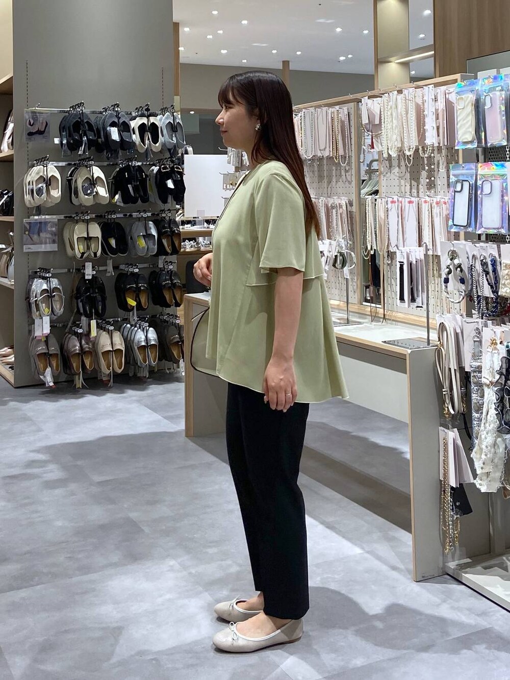 ホワイト系のバレエシューズ、ホワイト系のショルダーバッグ、イエロー系のシャツ/ブラウスを着用したレディースの夏コーディネートの2枚目の写真