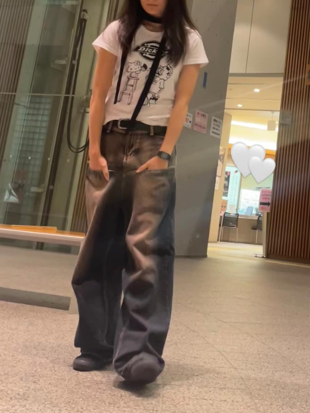 ホワイト系のTシャツ/カットソー、ブルー系のデニムパンツ、ブラック系のスニーカーを着用したレディースの秋コーディネートの2枚目の写真