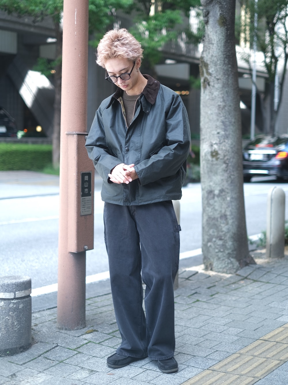 ブラック系のデニムパンツ、ブラウン系のニット/セーター、グリーン系のブルゾンを着用したメンズの秋コーディネートの3枚目の写真