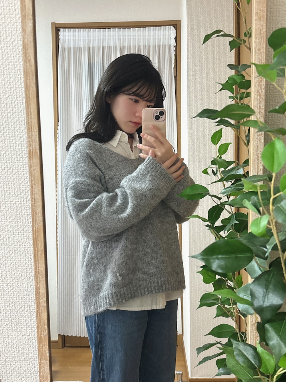 グレー系のニット/セーター、ブルー系のデニムパンツを着用したレディースの冬コーディネートの3枚目の写真