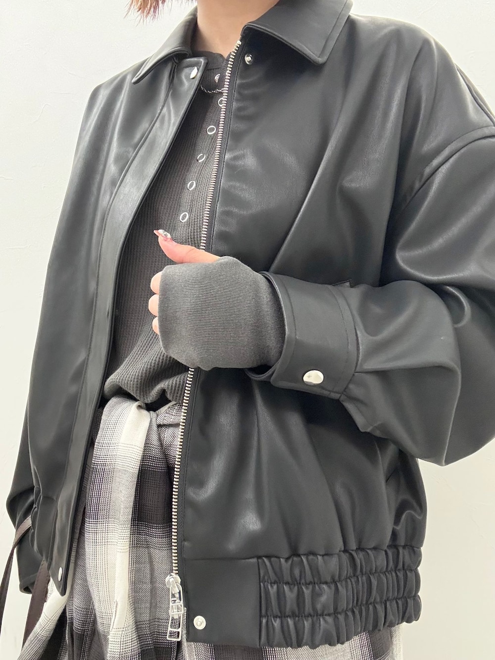 ブラック系のライダースジャケット、ブラック系のスラックス、ブラック系のシャツ/ブラウスを着用したレディースの夏コーディネートの5枚目の写真