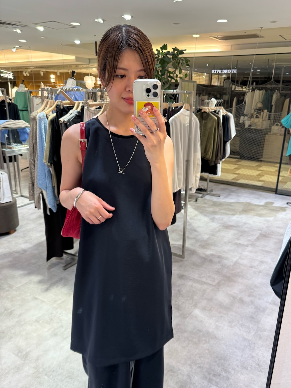 ブルー系のシャツ/ブラウス、ブルー系のその他パンツ、レッド系のハンドバッグを着用したレディースの夏コーディネートの2枚目の写真