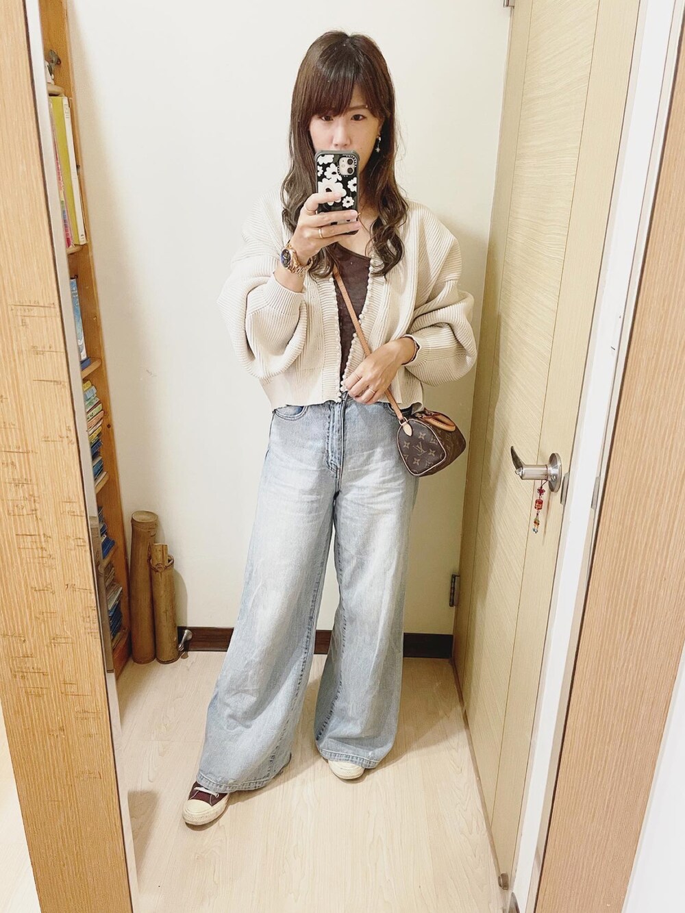 ブルー系のデニムパンツ、ブラウン系のスニーカー、その他のバックパック/リュックを着用したレディースの秋コーディネートの2枚目の写真