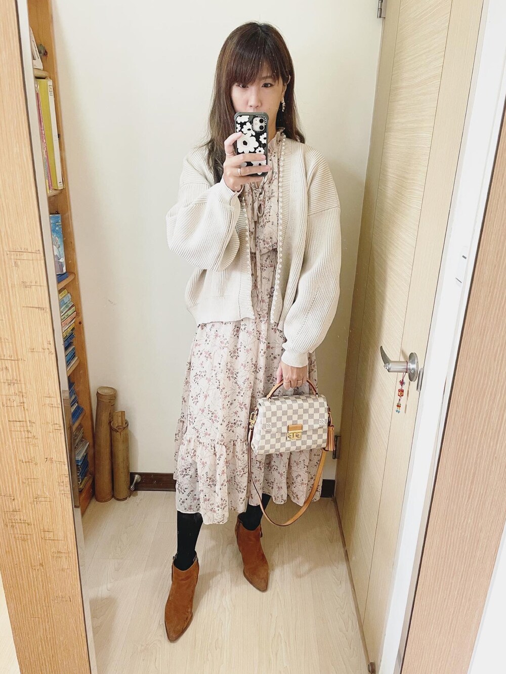 ベージュ系のカーディガン/ボレロ、その他のショルダーバッグ、ブラウン系のブーツを着用したレディースの冬コーディネートの2枚目の写真