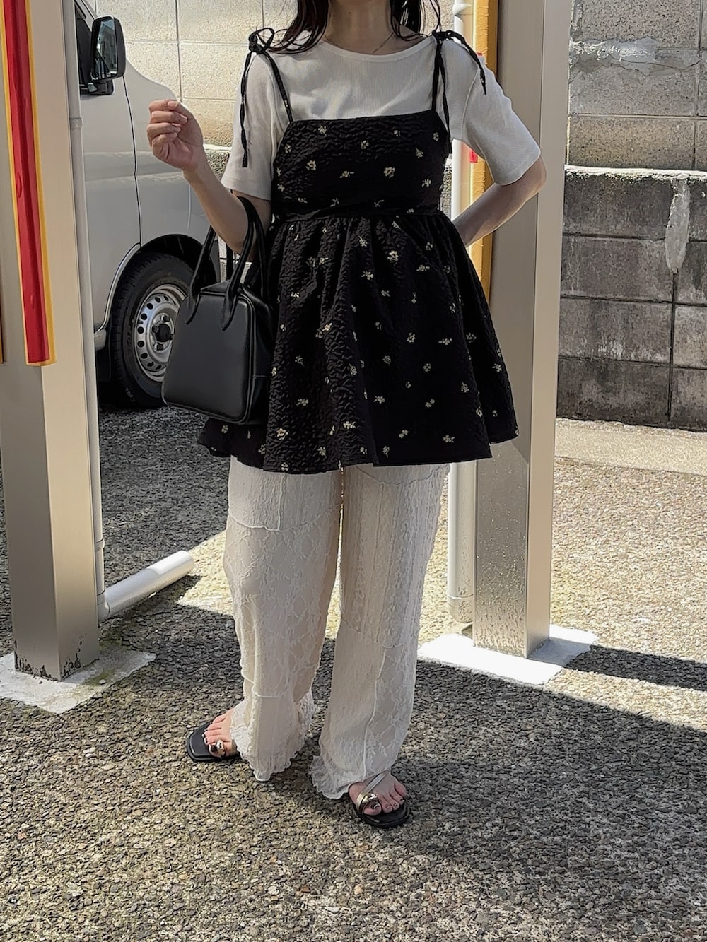 ベージュ系のその他パンツ、ブラウン系のサンダル、ホワイト系のTシャツ/カットソーを着用したレディースの秋コーディネートの2枚目の写真