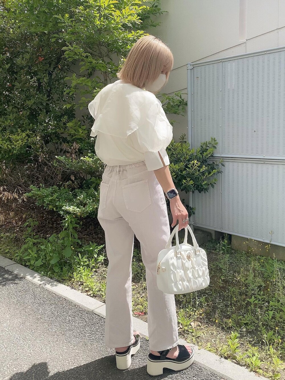 ホワイト系のボストンバッグ、ホワイト系のシャツ/ブラウス、ピンク系のデニムパンツを着用したレディースの春コーディネートの2枚目の写真