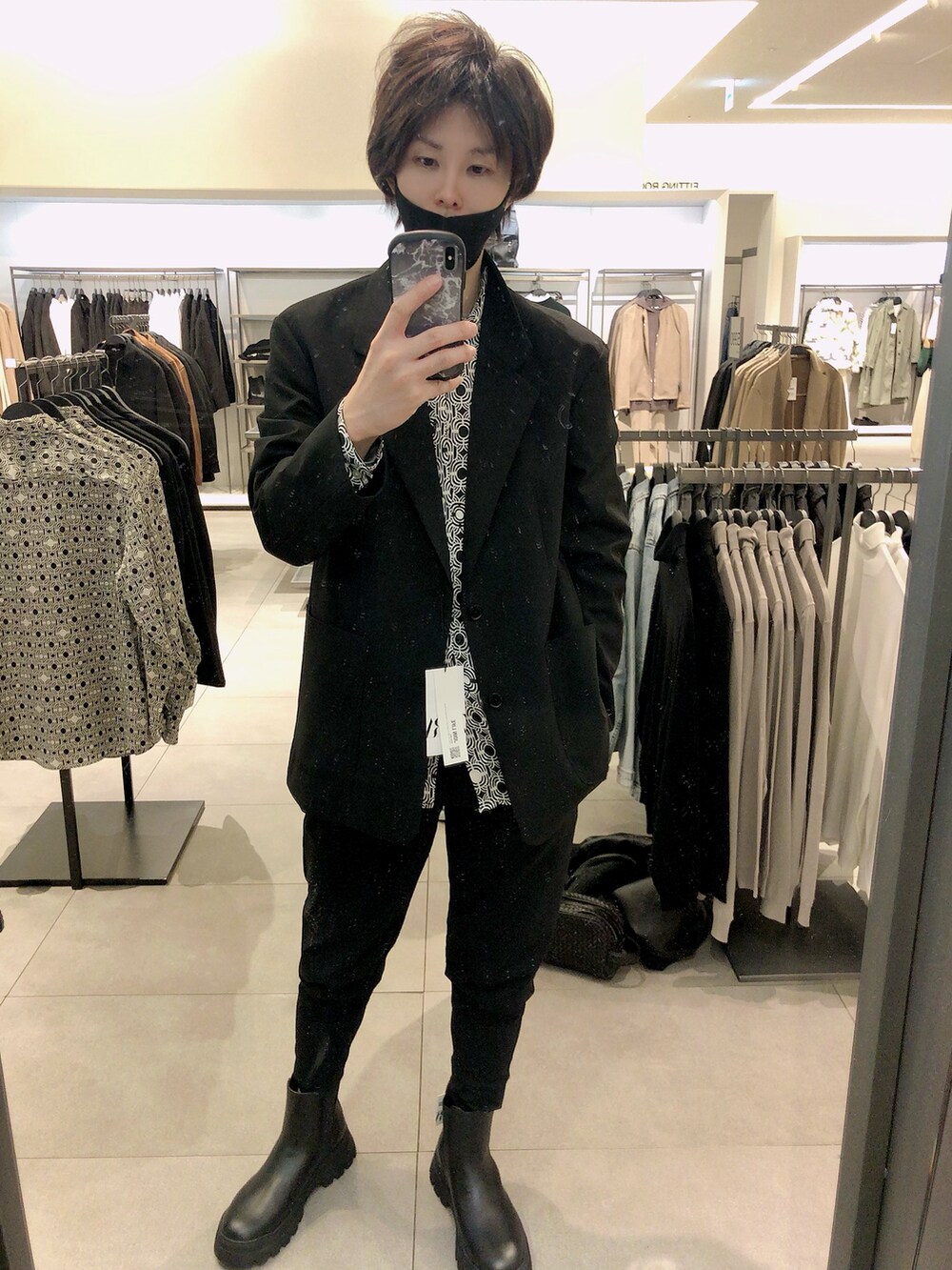 ブラック系のテーラードジャケット、ブラック系のスラックス、ブラック系のブーツを着用したメンズの秋コーディネートの3枚目の写真