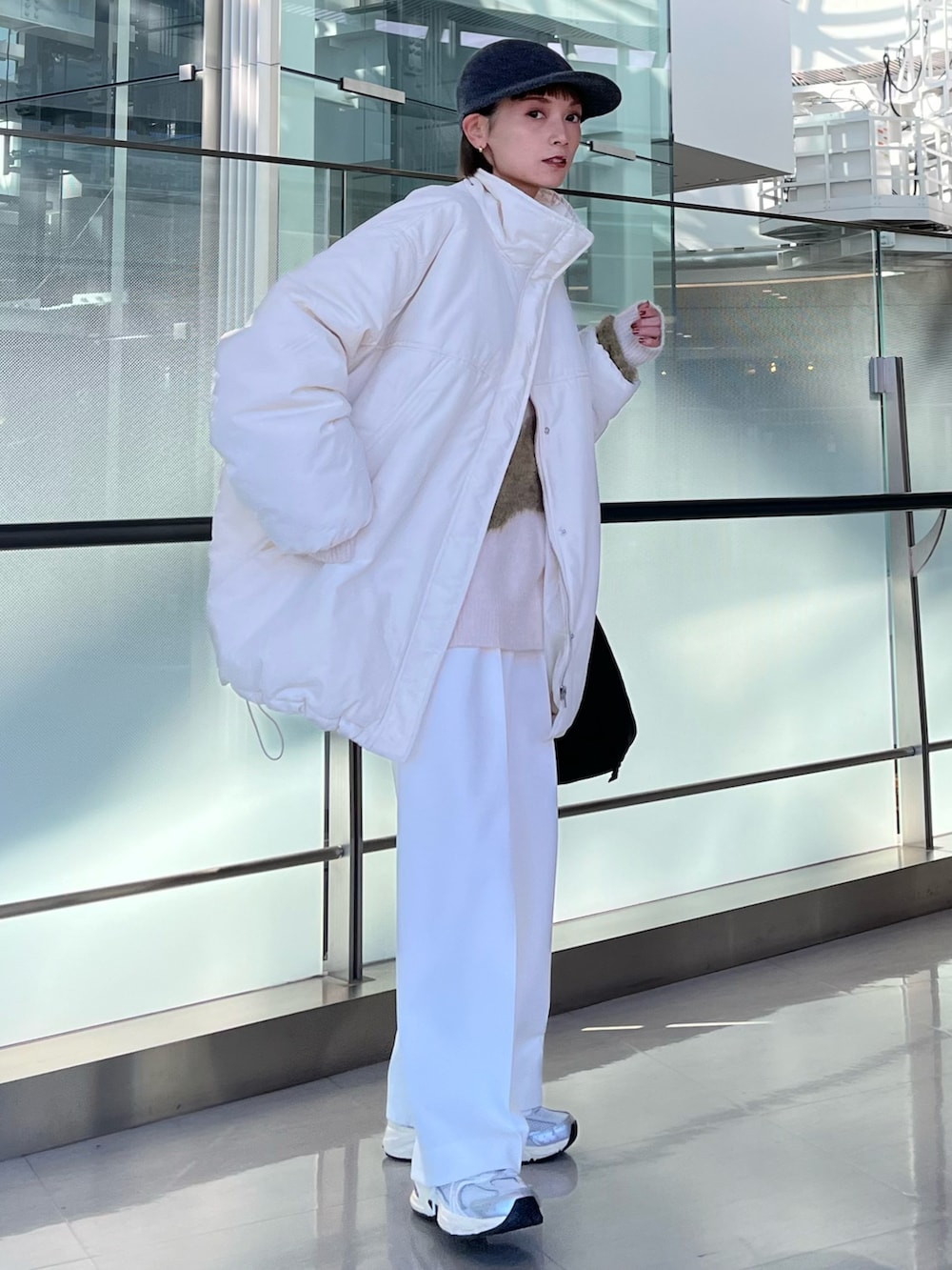 ホワイト系のパンツ、ホワイト系のダウンジャケット/コート、ホワイト系のニット/セーターを着用したレディースの冬コーディネートの2枚目の写真