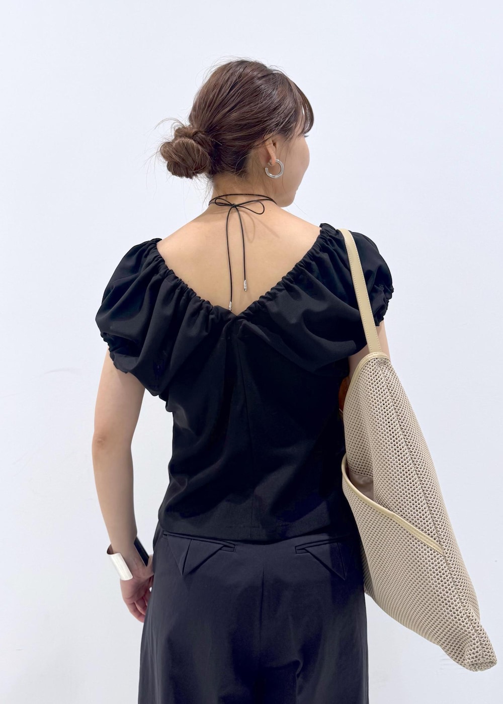 ベージュ系のショルダーバッグ、ブラック系のサンダル、ブラック系のその他パンツを着用したレディースの春コーディネートの6枚目の写真