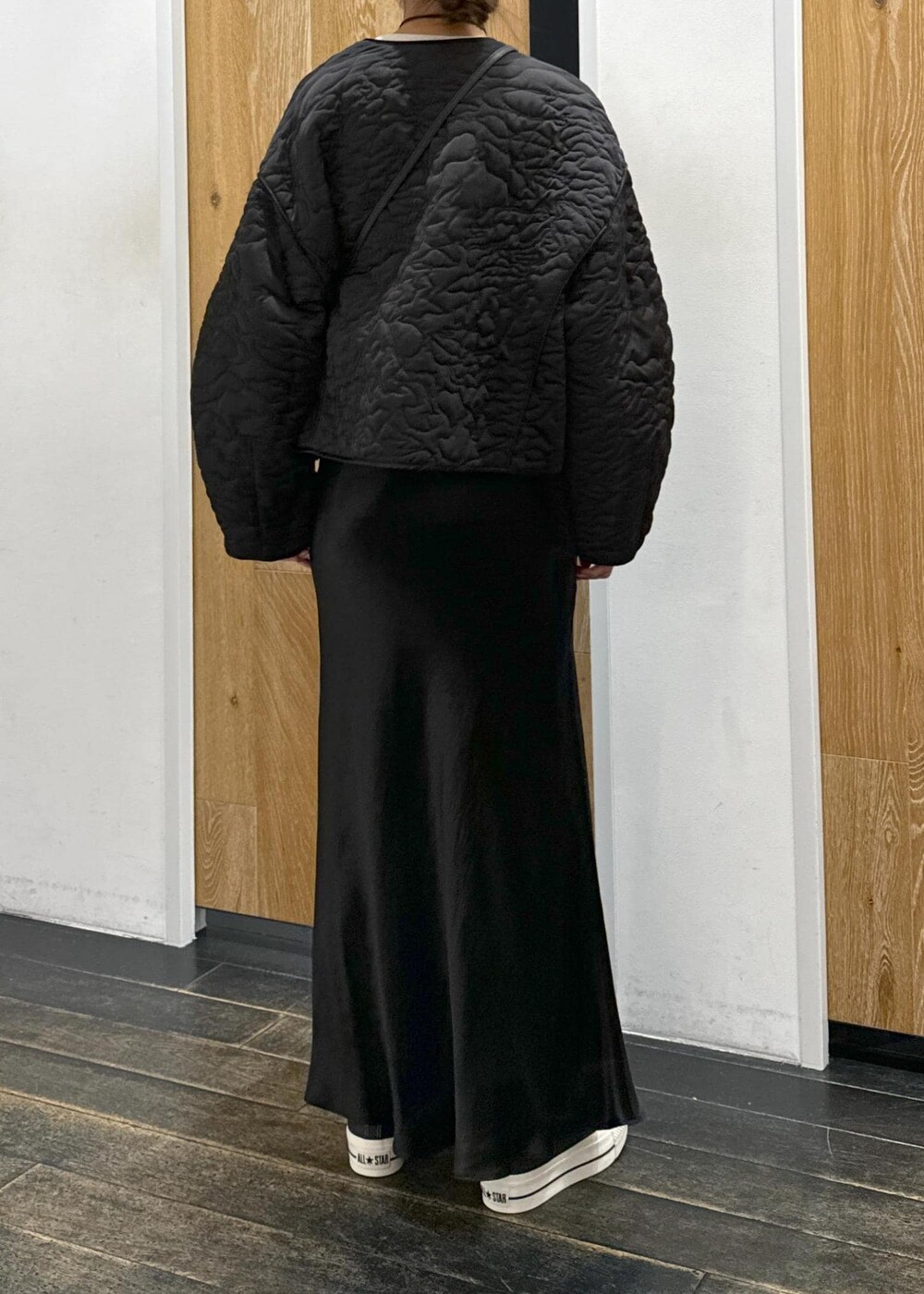 ホワイト系のスウェット、ブラック系のスカート、ブラック系のブルゾンを着用したレディースの冬コーディネートの3枚目の写真