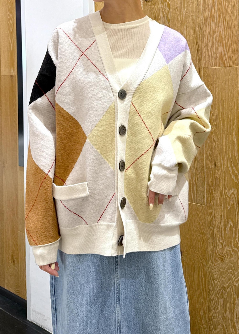 ブラウン系のショルダーバッグ、ブラック系のブーツ、ホワイト系のTシャツ/カットソーを着用したレディースの秋コーディネートの4枚目の写真