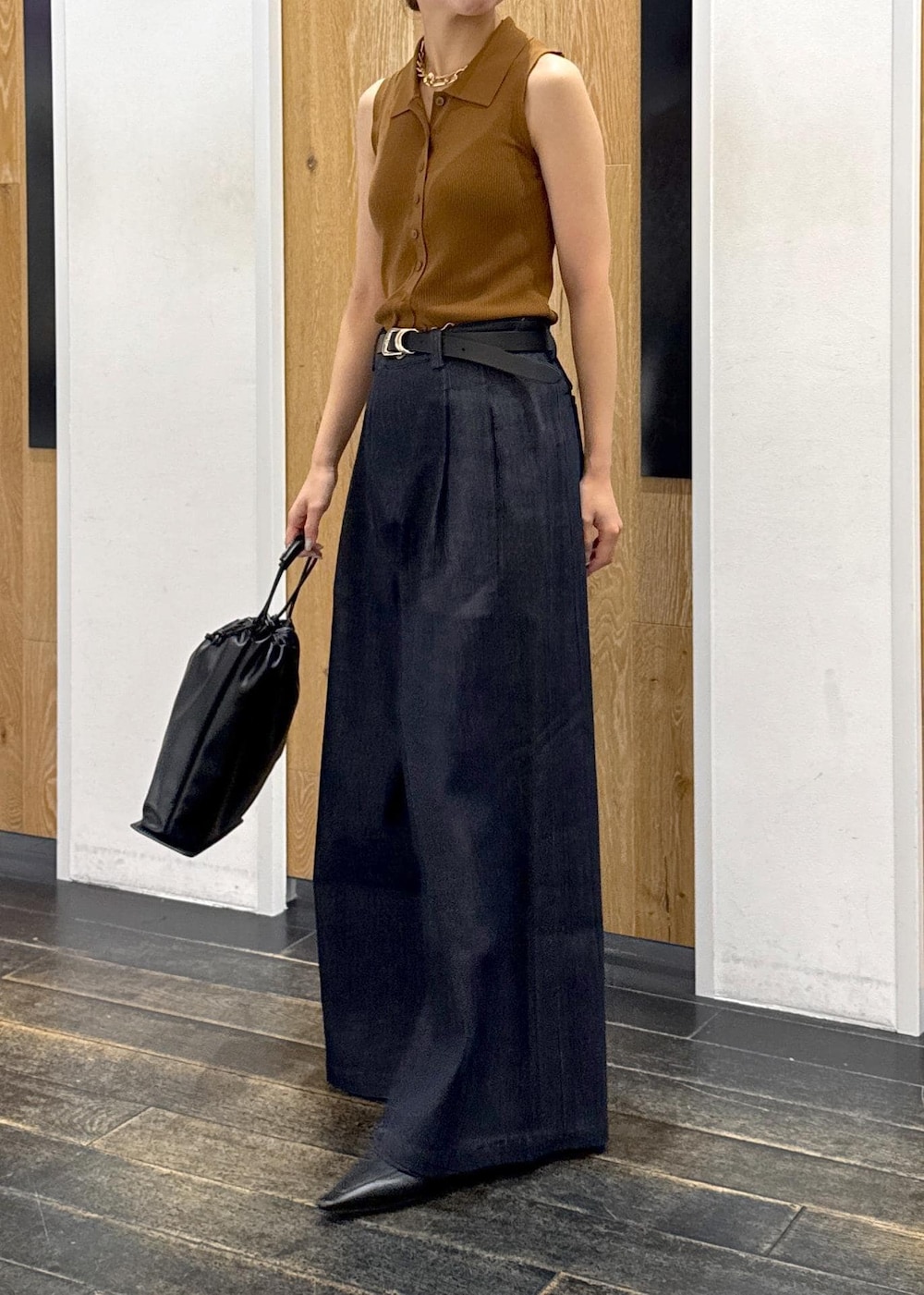 ブラウン系のニット/セーター、ブルー系のデニムパンツ、ブラック系のショルダーバッグを着用したレディースの夏コーディネートの2枚目の写真