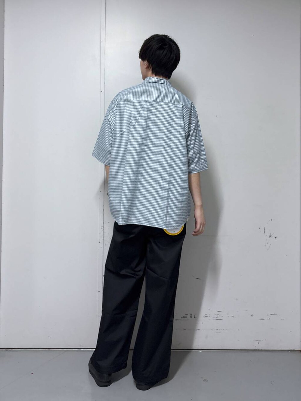 ブラック系のチノパンツ、ホワイト系のシャツ/ブラウス、ホワイト系のタンクトップを着用したメンズの春コーディネートの3枚目の写真