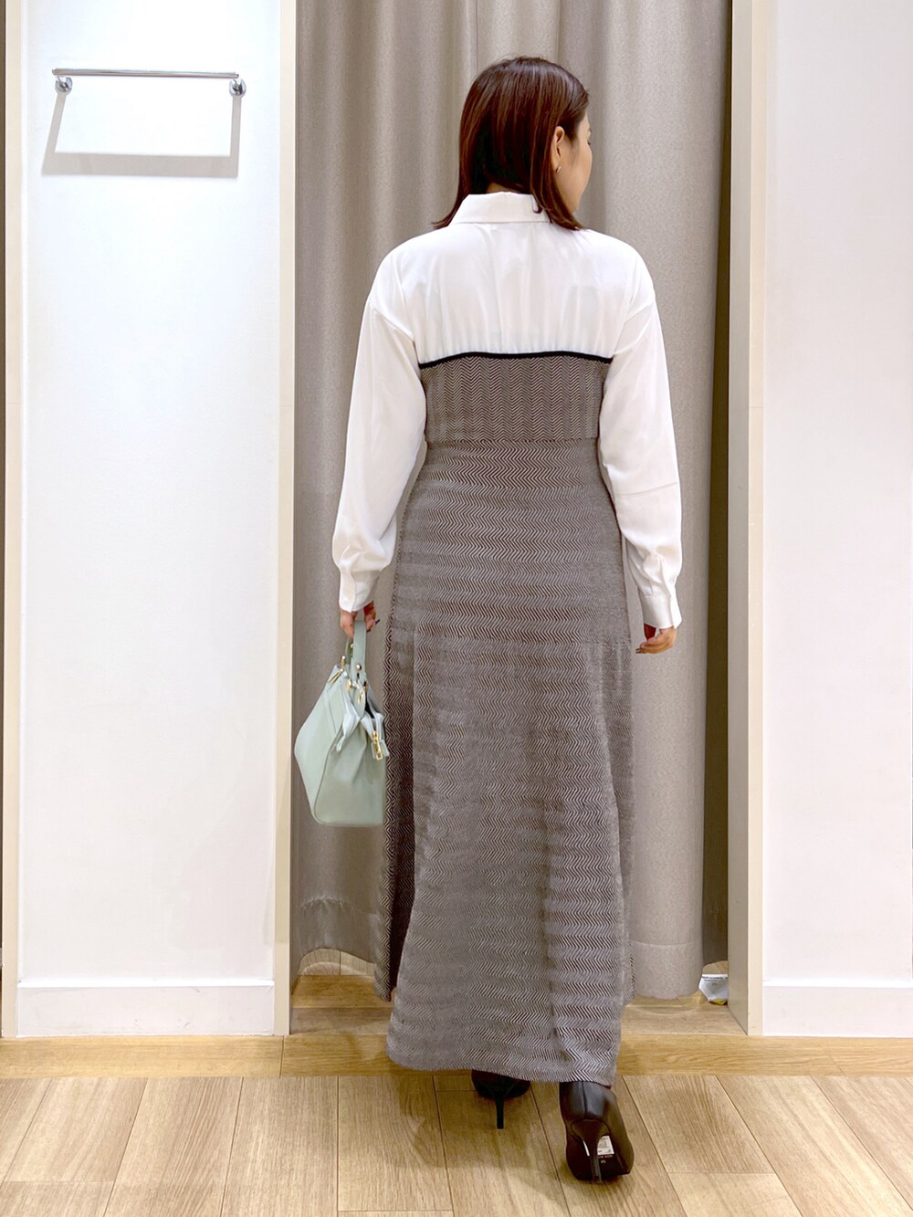 ブラック系のカーディガン/ボレロ、ブラック系のワンピース、グリーン系のショルダーバッグを着用したレディースの冬コーディネートの5枚目の写真