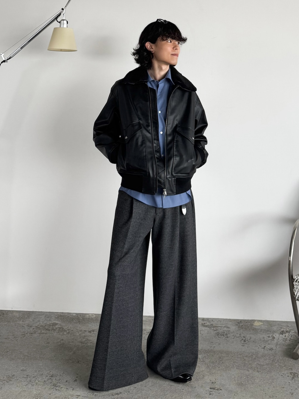 ブラック系のブルゾン、ブルー系のシャツ/ブラウス、グレー系のスラックスを着用したメンズの秋コーディネートの4枚目の写真