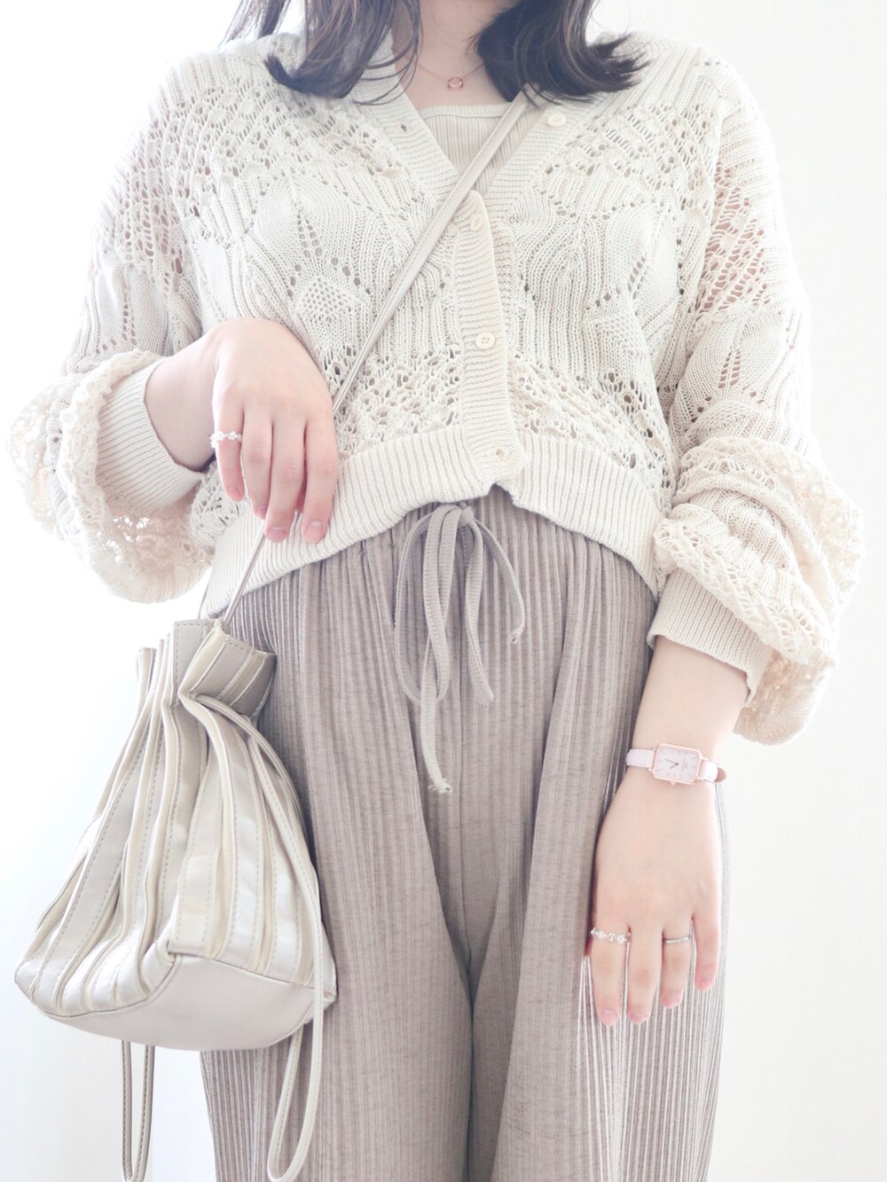 ベージュ系のカーディガン/ボレロ、ブラウン系のその他パンツ、シルバー系のバッグを着用したレディースの春コーディネートの3枚目の写真