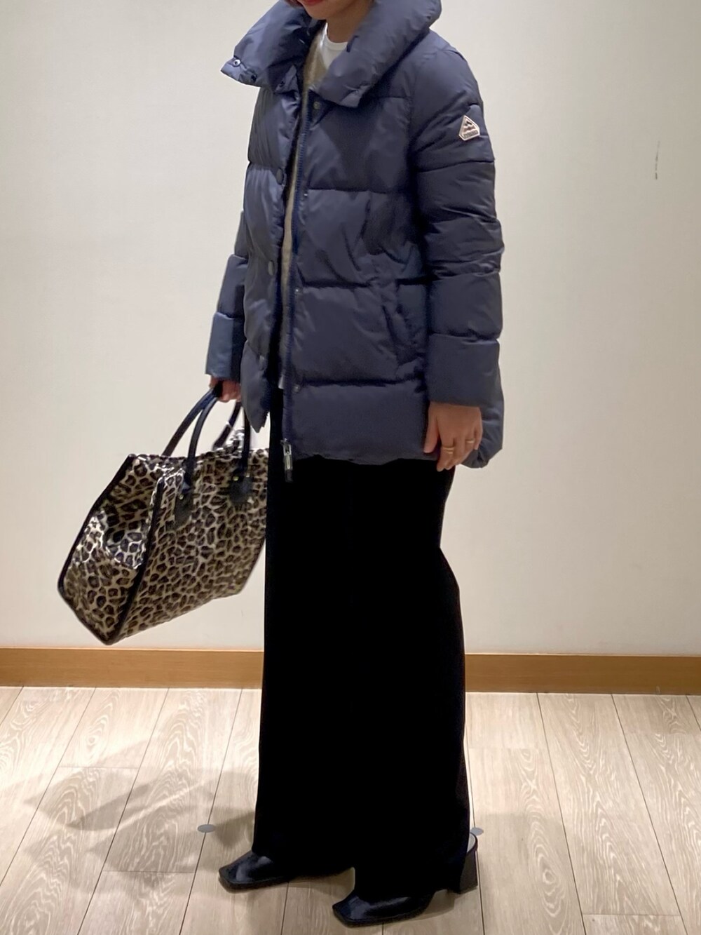 ブラック系のその他パンツ、グレー系のダウンジャケット/コート、イエロー系のニット/セーターを着用したレディースの冬コーディネートの8枚目の写真