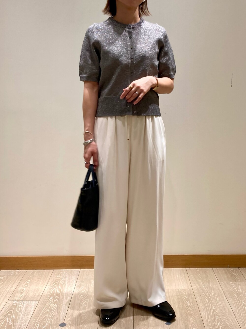 ホワイト系のその他パンツ、ブラック系のショルダーバッグ、グレー系のニット/セーターを着用したレディースの秋コーディネートの7枚目の写真