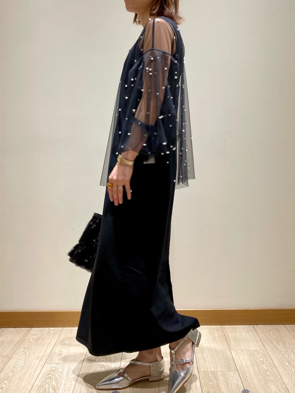 ブラック系のワンピース、ブラック系のTシャツ/カットソー、ブラック系のハンドバッグを着用したレディースの秋コーディネートの5枚目の写真