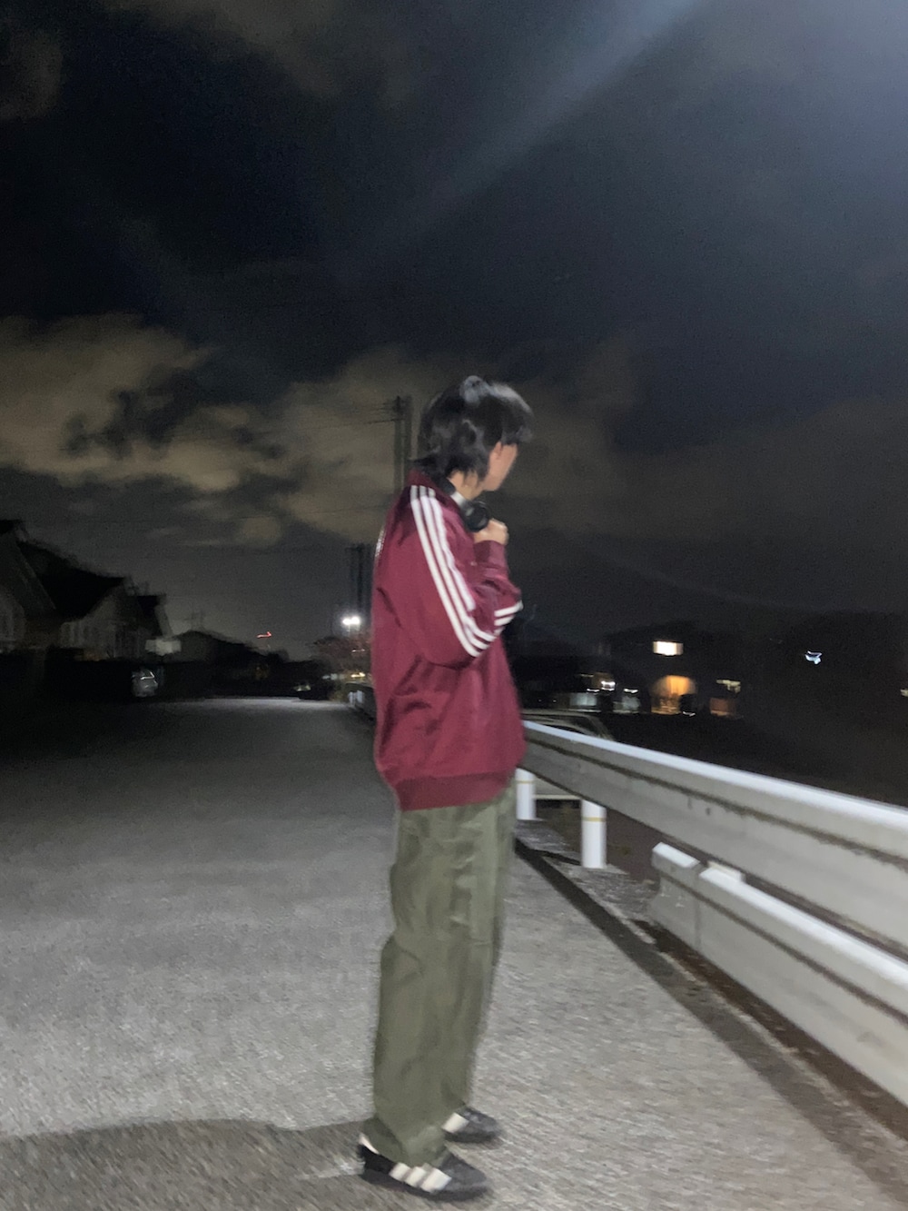 レッド系のジャージ、グリーン系のカーゴパンツ、ブラック系のスニーカーを着用したメンズの冬コーディネートの2枚目の写真