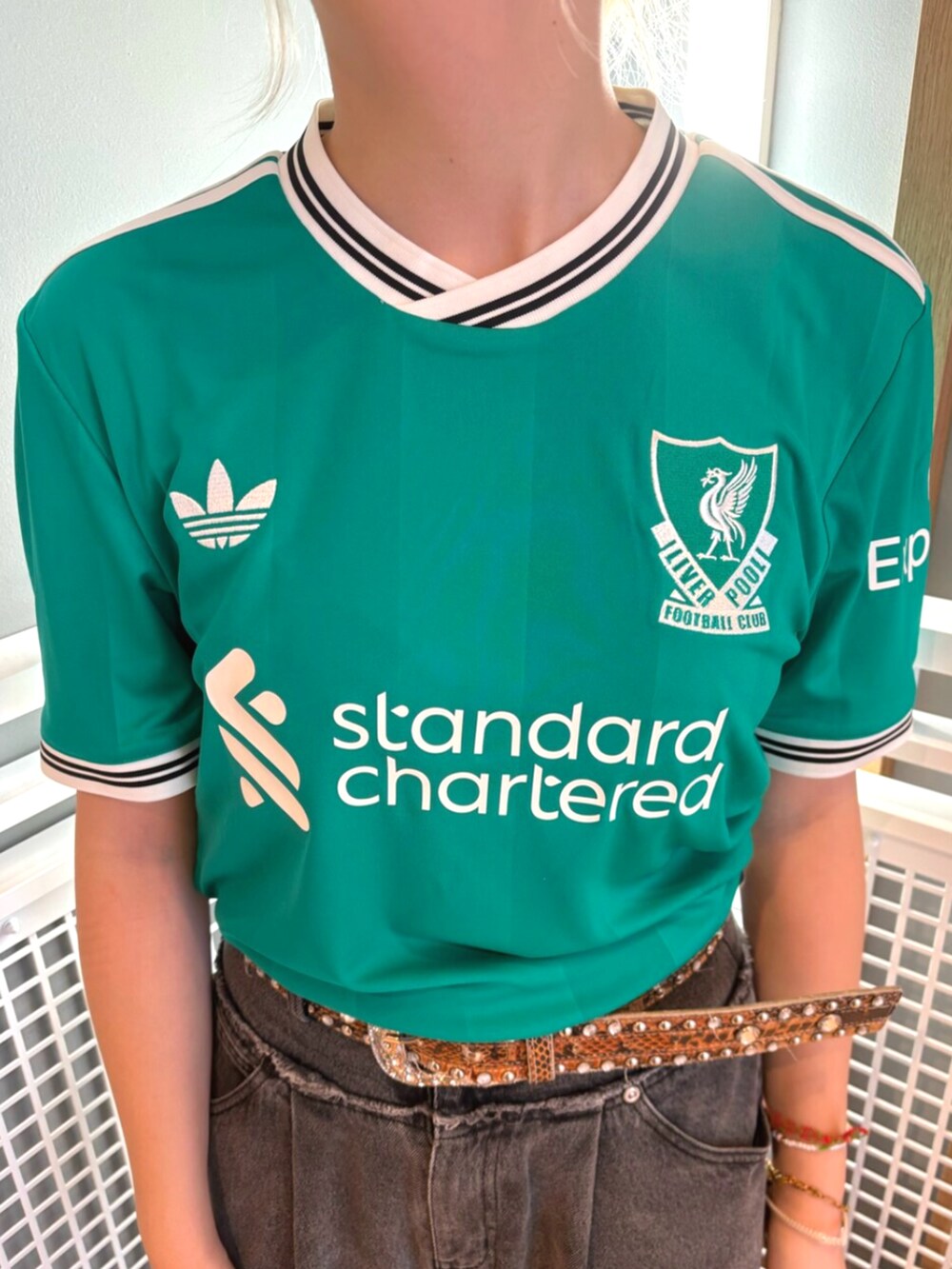 グリーン系のTシャツ/カットソー、ホワイト系のスニーカーを着用したレディースの秋コーディネートの2枚目の写真