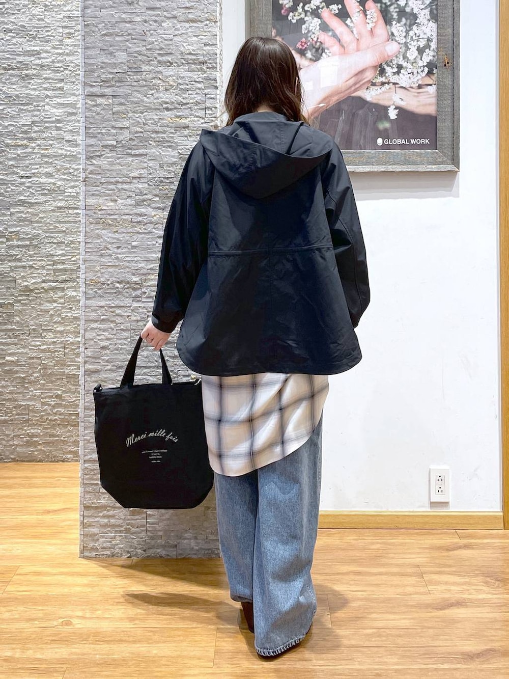 ブルー系のデニムパンツ、ブラック系のパンプス、ブルー系のマウンテンパーカーを着用したレディースの春コーディネートの3枚目の写真