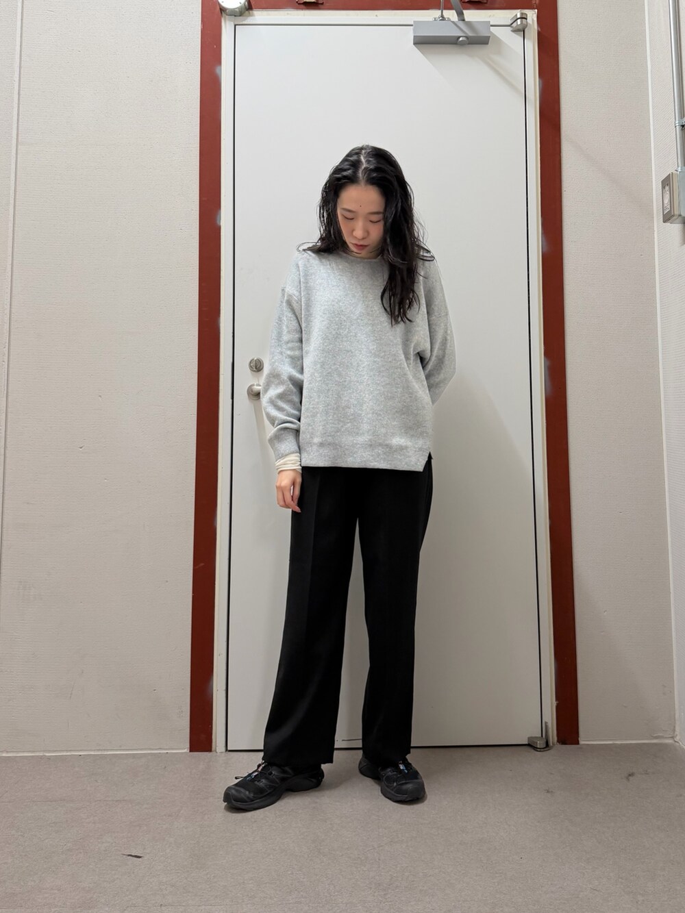 ホワイト系のダウンジャケット/コート、グレー系のニット/セーター、ブラック系のその他パンツを着用したレディースの冬コーディネートの4枚目の写真