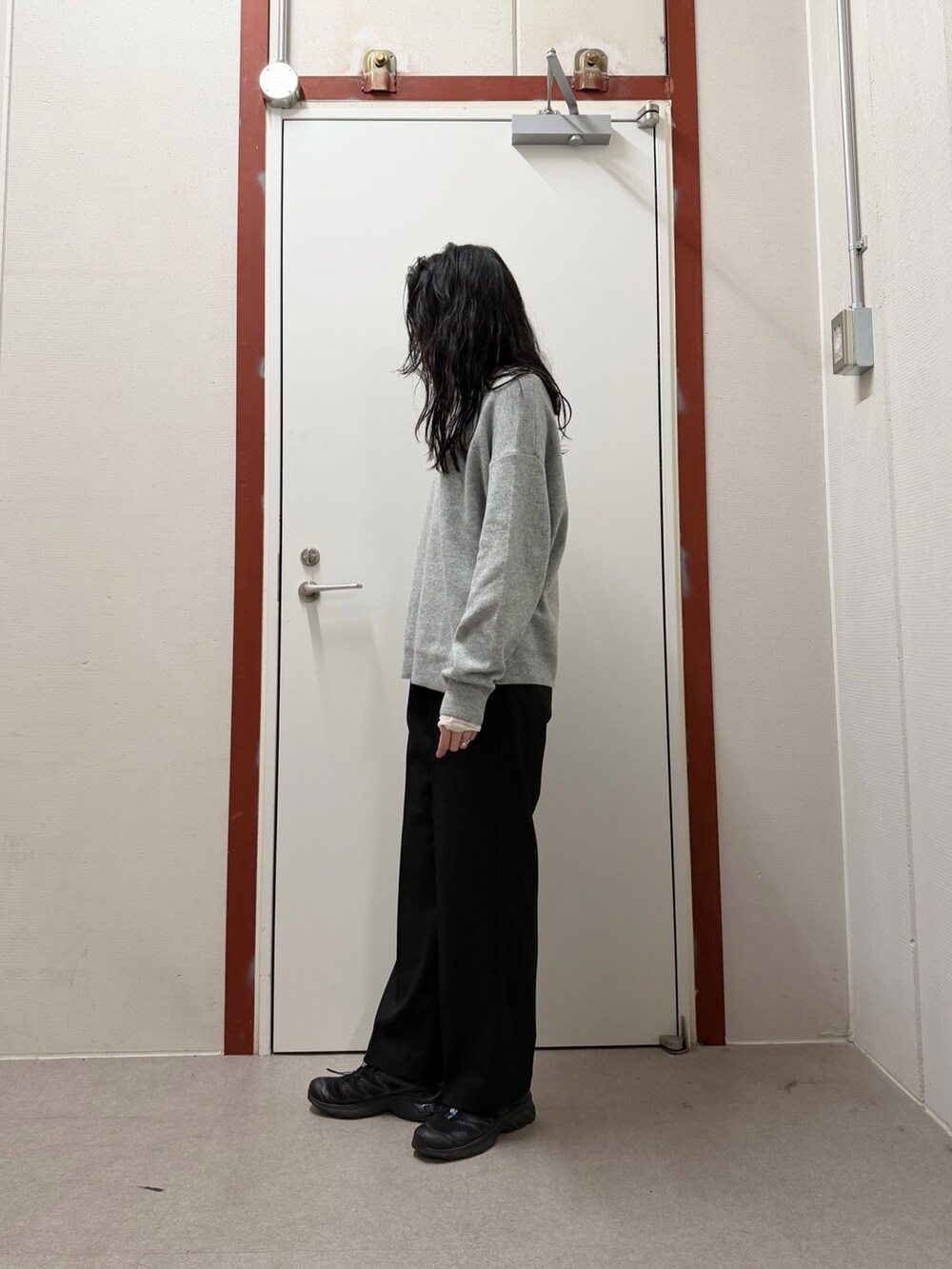 ホワイト系のダウンジャケット/コート、グレー系のニット/セーター、ブラック系のその他パンツを着用したレディースの冬コーディネートの5枚目の写真