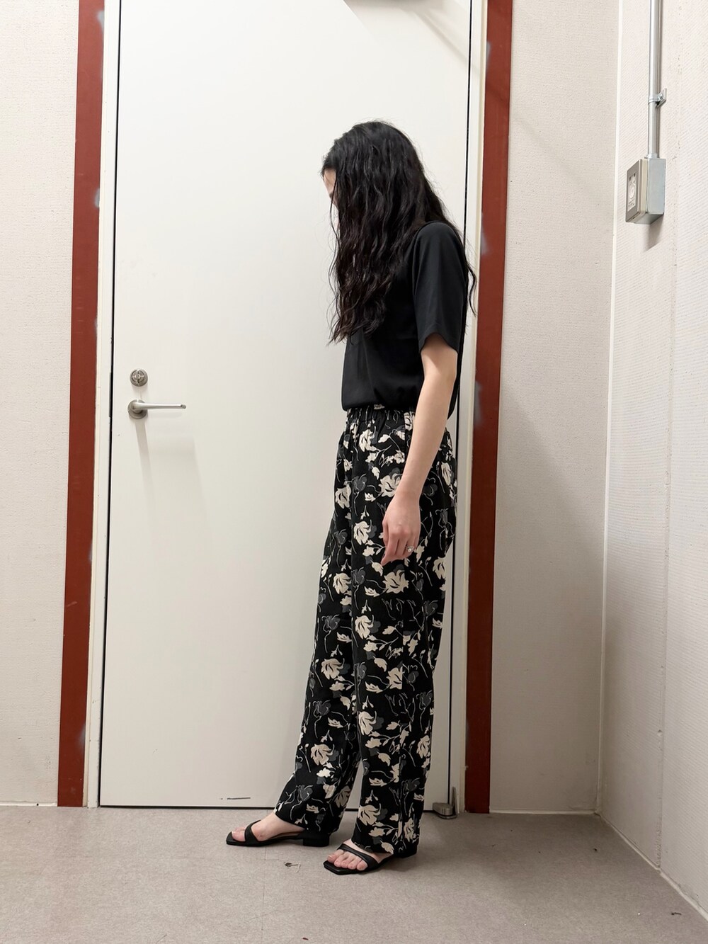 ブラック系のTシャツ/カットソー、ブラック系のその他パンツ、ブラック系のサンダルを着用したレディースの春コーディネートの2枚目の写真