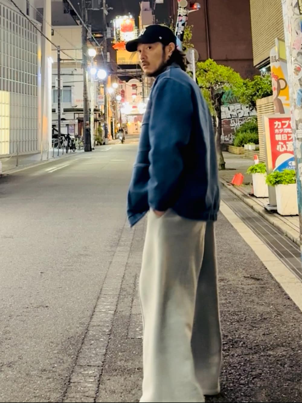 ブルー系のデニムジャケット、グレー系のその他パンツ、ブラック系のスニーカーを着用したメンズの春コーディネートの2枚目の写真