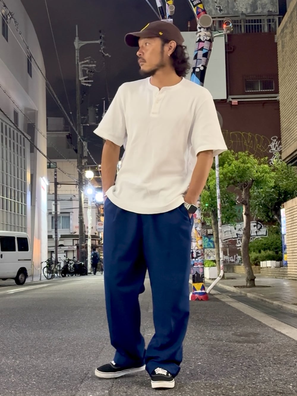 ブラック系のスニーカー、ホワイト系のTシャツ/カットソー、ブルー系のパンツを着用したメンズの夏コーディネートの2枚目の写真