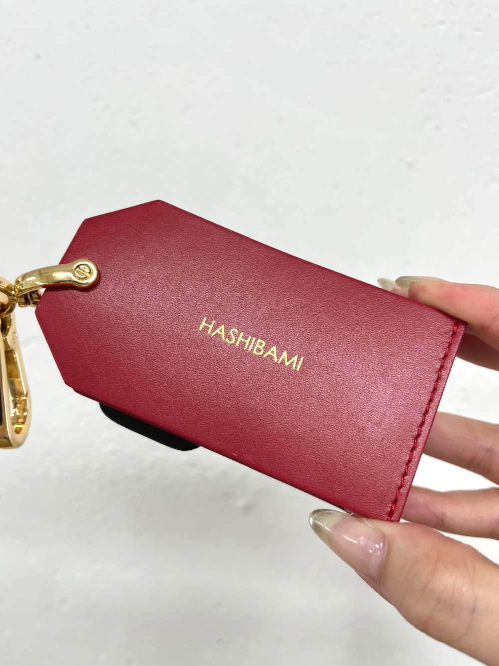 レッド系のキーホルダーを着用したレディースの冬コーディネートの4枚目の写真