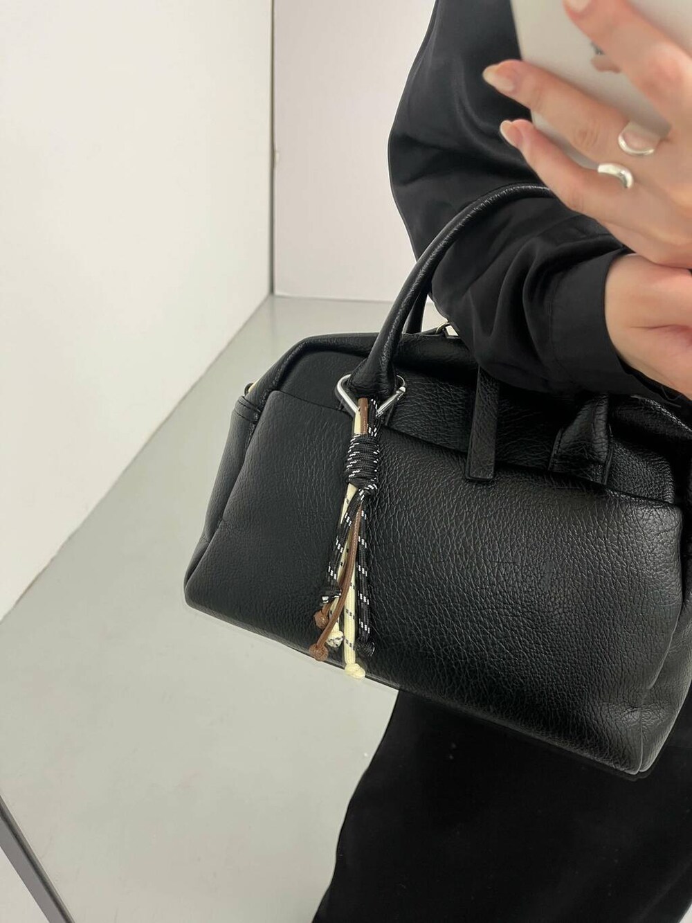 ブラック系のボストンバッグ、イエロー系のキーホルダー、ブラック系のキーホルダーを着用したレディースの夏コーディネートの5枚目の写真