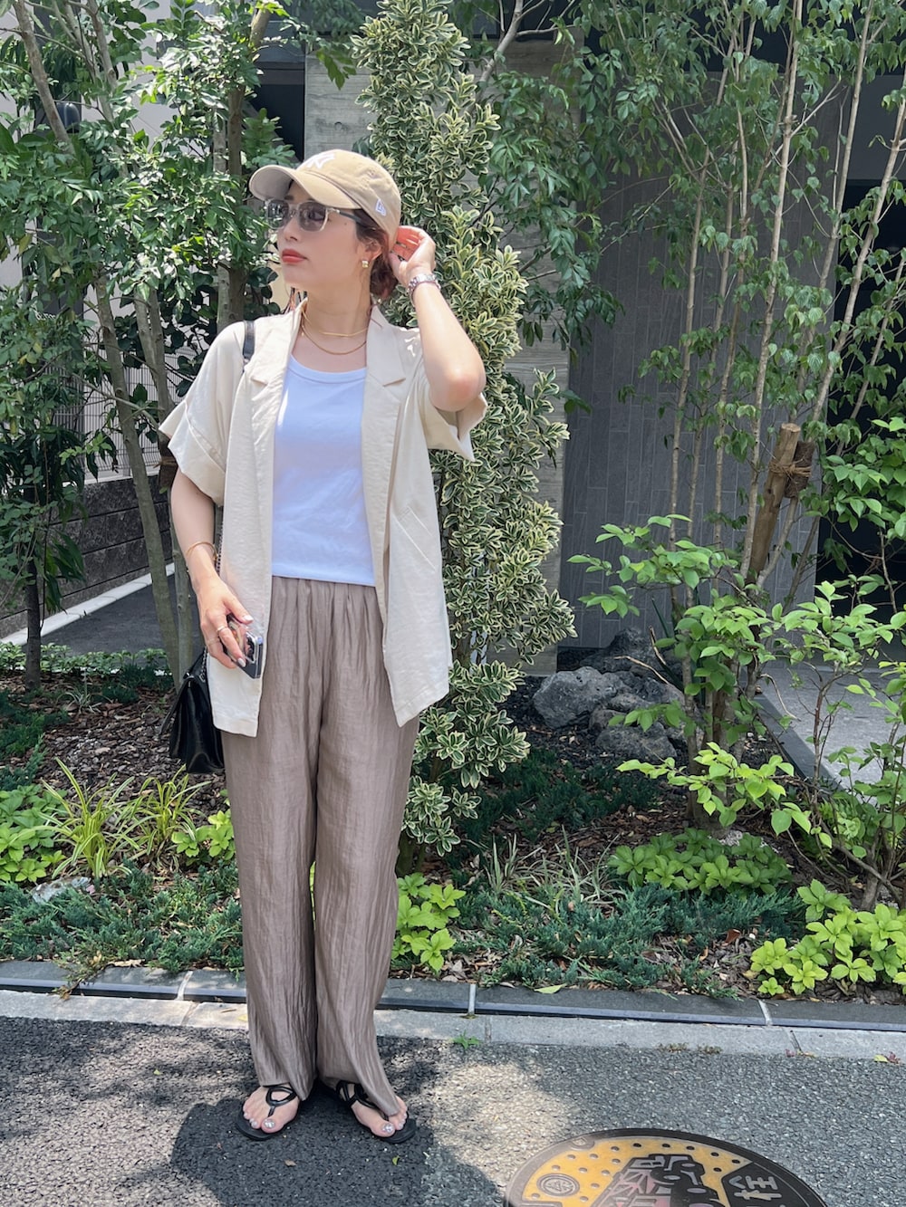 ホワイト系のタンクトップ、ベージュ系のテーラードジャケット、ベージュ系のパンツを着用したレディースの春コーディネートの3枚目の写真