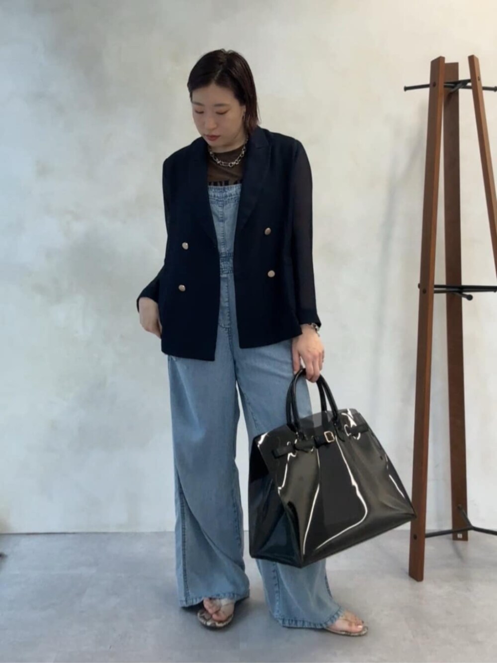 ブルー系のテーラードジャケット、ブラック系のショルダーバッグ、ブルー系のつなぎ/オールインワンを着用したレディースの夏コーディネートの7枚目の写真
