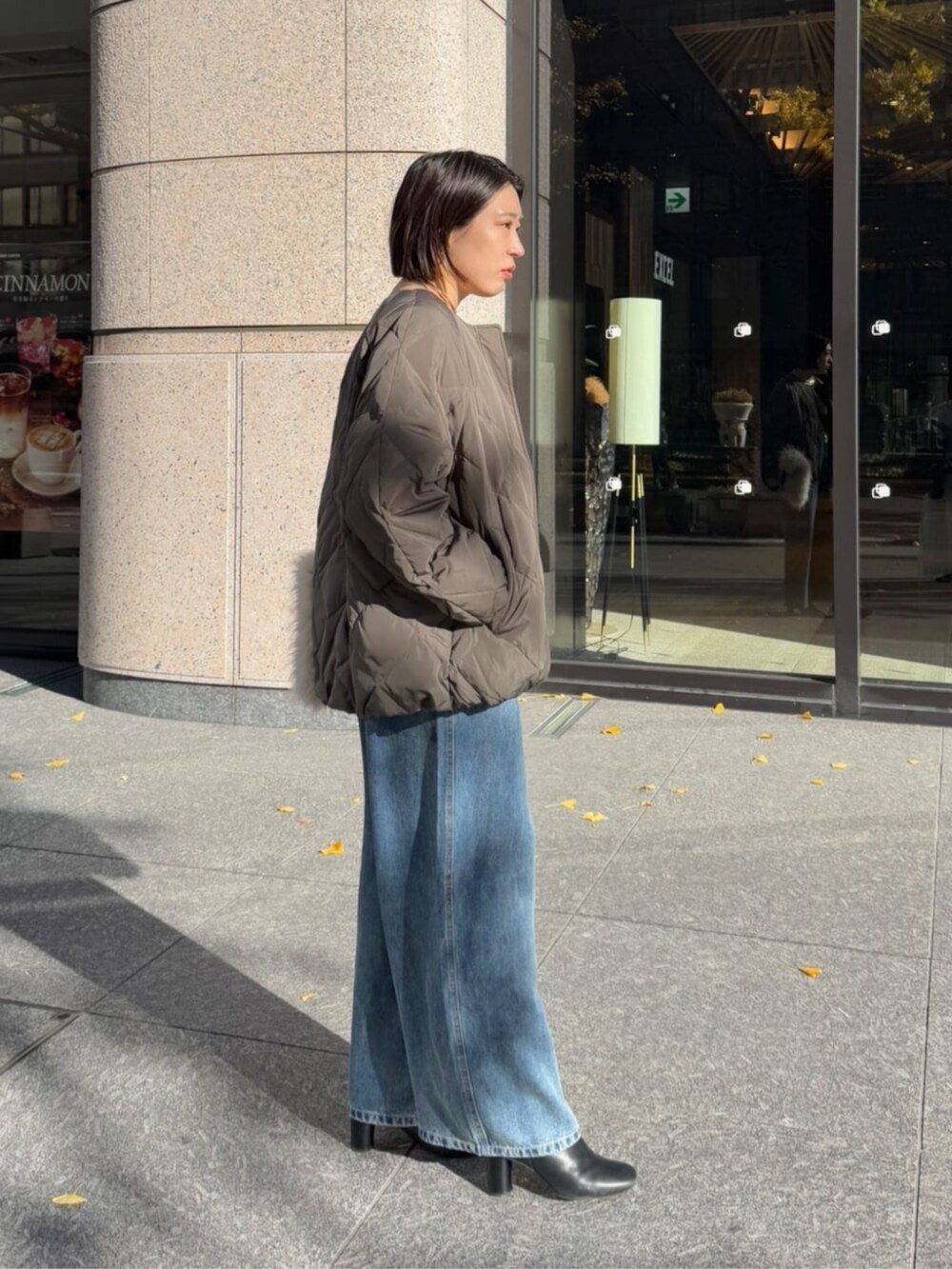 ホワイト系のショルダーバッグ、ブルー系のデニムパンツ、グレー系のその他アウターを着用したレディースの冬コーディネートの8枚目の写真
