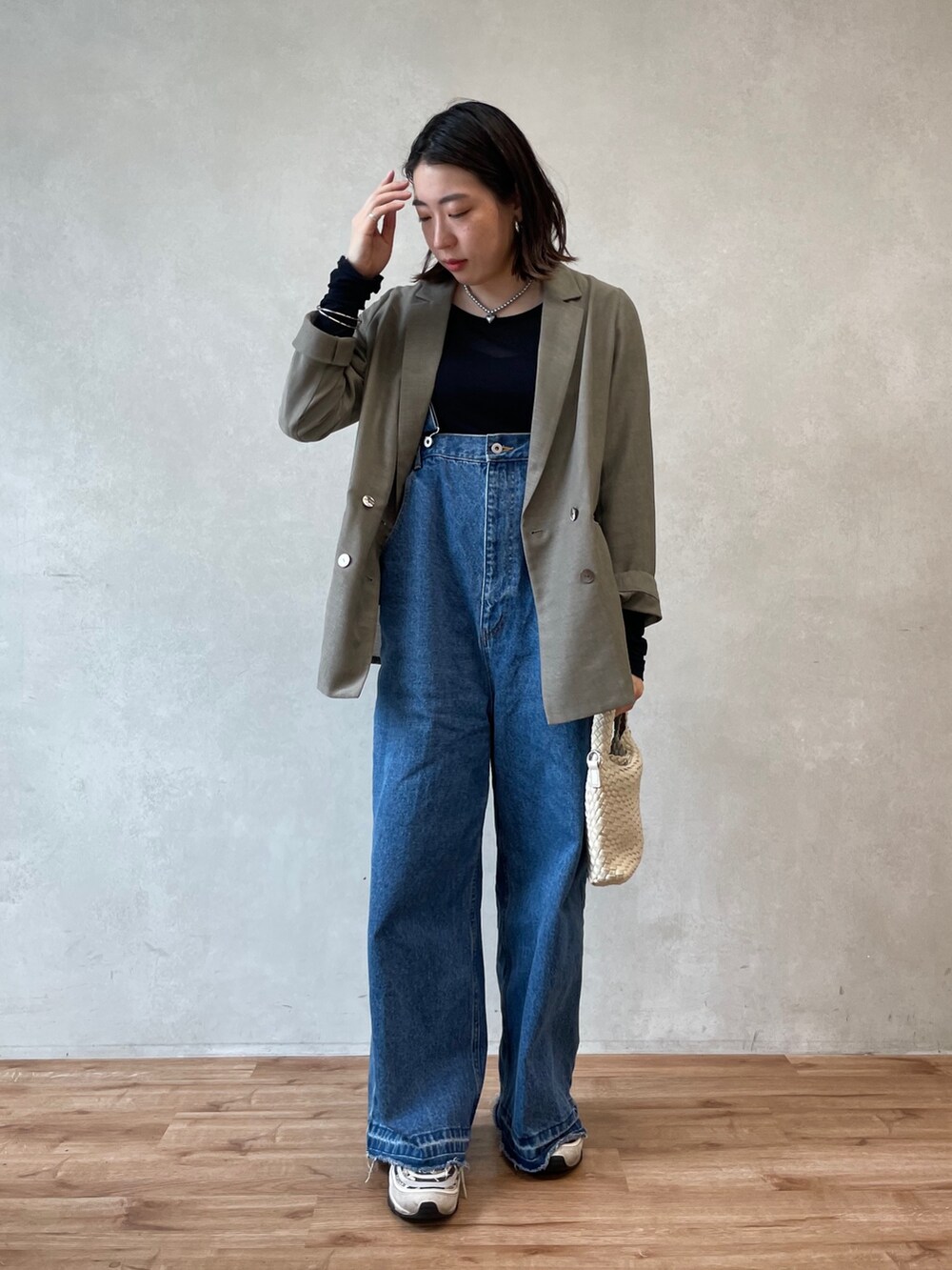 ブルー系のサロペット/オーバーオール、ベージュ系のテーラードジャケット、ブルー系のTシャツ/カットソーを着用したレディースの春コーディネートの2枚目の写真