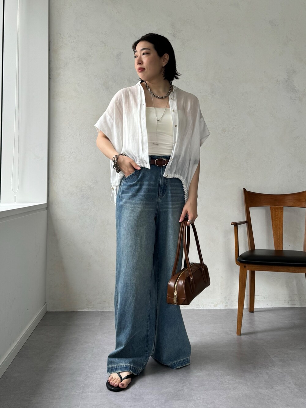 ブルー系のデニムパンツ、ホワイト系のシャツ/ブラウスを着用したレディースの夏コーディネートの9枚目の写真