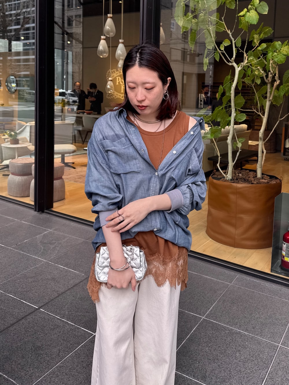 ブルー系のシャツ/ブラウス、ブラウン系のTシャツ/カットソー、ベージュ系のデニムパンツを着用したレディースの春コーディネートの4枚目の写真