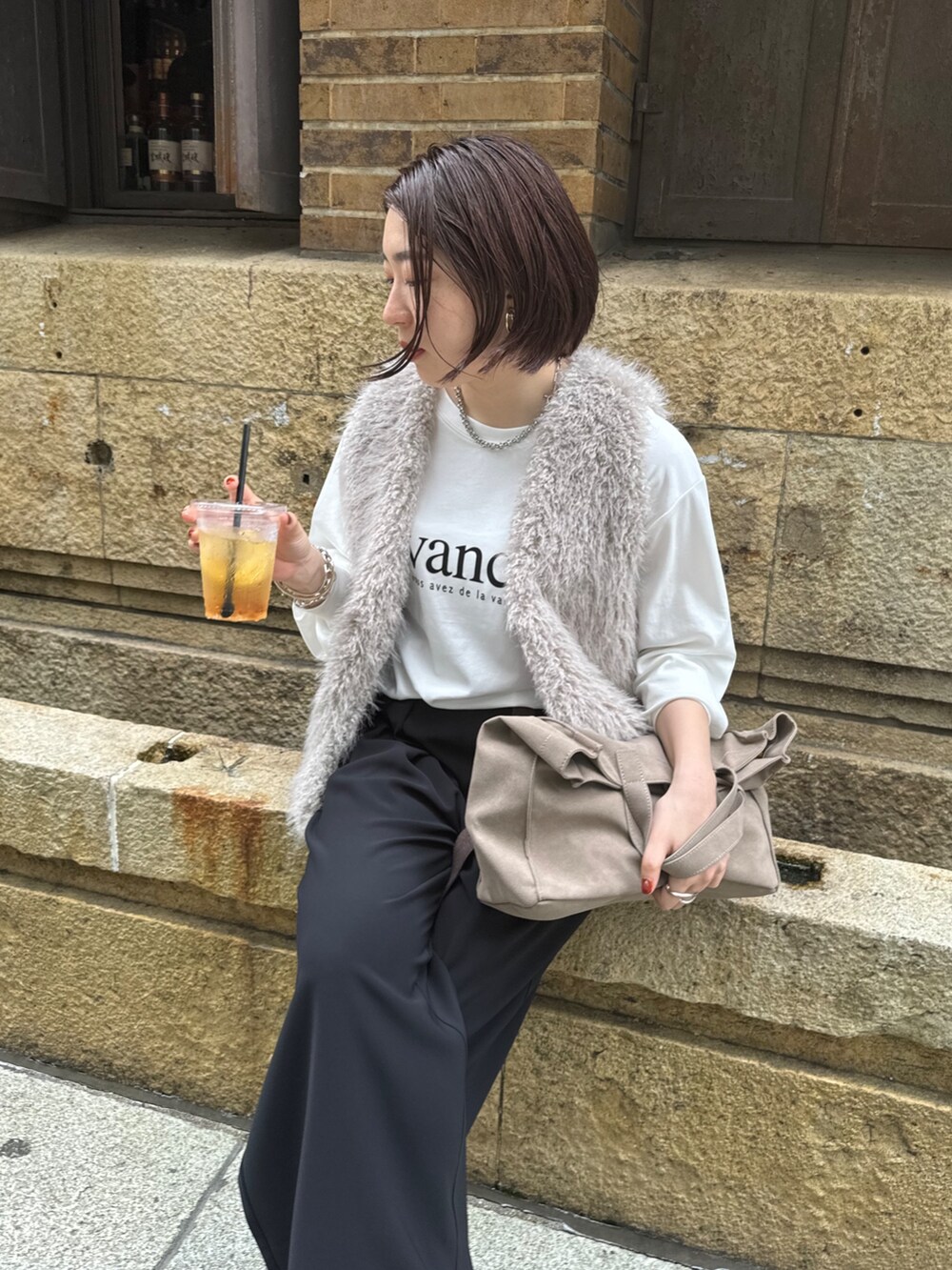 ブラック系のスラックス、グレー系のベスト、ホワイト系のTシャツ/カットソーを着用したレディースの夏コーディネートの3枚目の写真